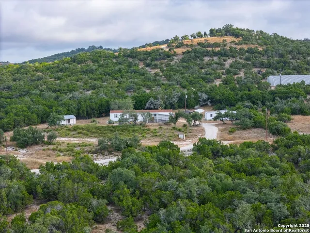 a view of a town with barn trees