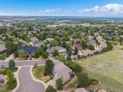 an aerial view of a house with a yard