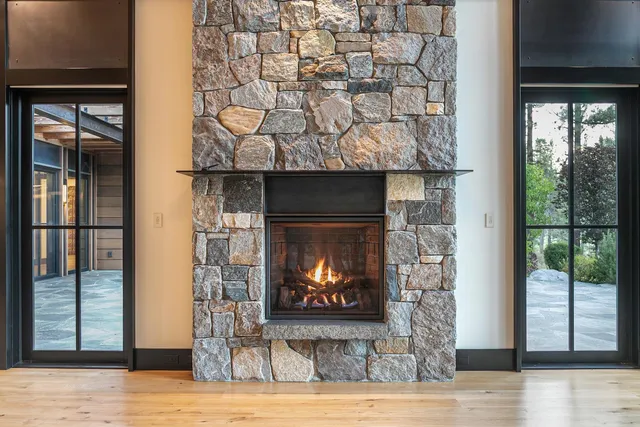 a bed sitting in a spacious bedroom next to a window