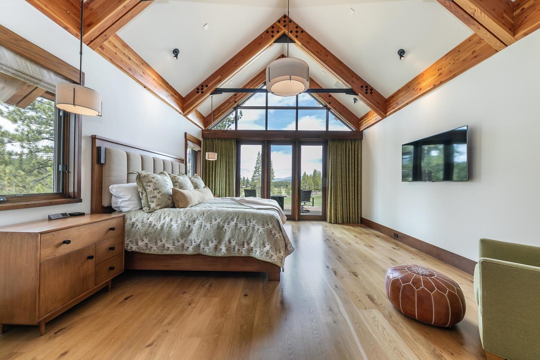 11454 Henness Road Truckee, CA 96161 - Photo 13 of 27 a bedroom with a large bed and a tv on table