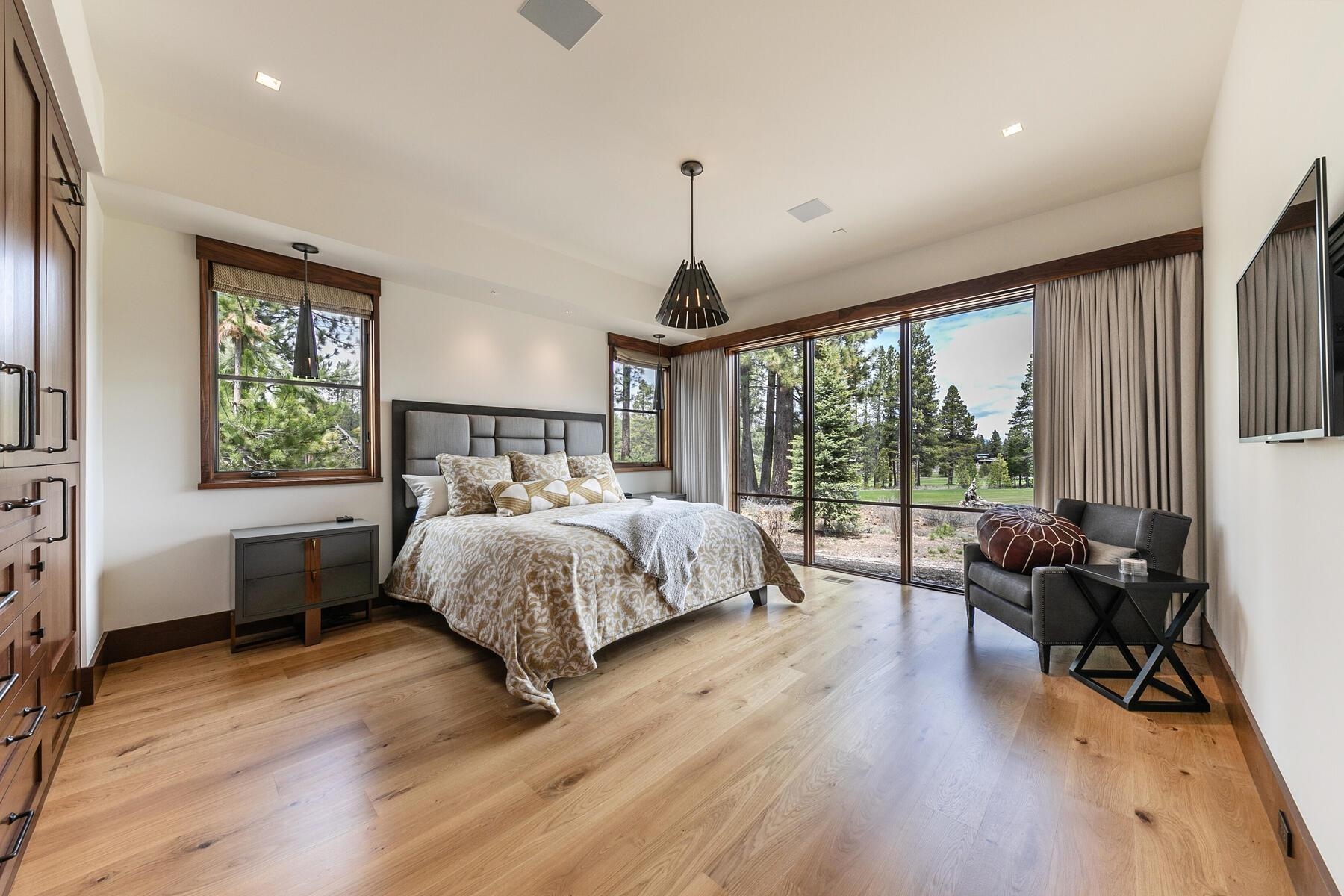 11454 Henness Road Truckee, CA 96161 - Photo 14 of 27 a bed sitting in a spacious bedroom next to a window