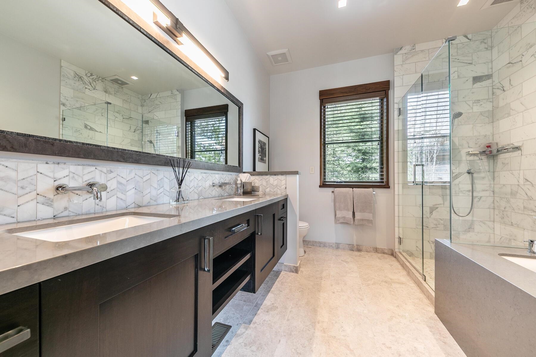11454 Henness Road Truckee, CA 96161 - Photo 16 of 27 a spacious bathroom with a granite countertop sink mirror and double