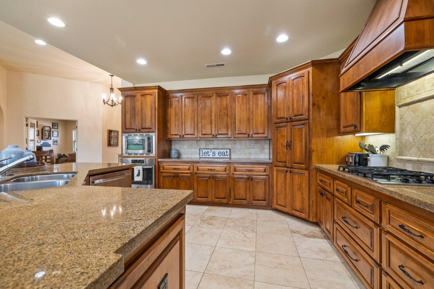 16 Flagstone Court Copperopolis, CA 95228 - Photo 12 of 45 a kitchen with stainless steel appliances granite countertop a sink counter space cabinets and a large window
