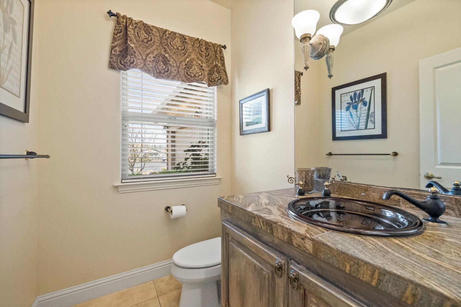 16 Flagstone Court Copperopolis, CA 95228 - Photo 23 of 45 a bathroom with a sink a toilet and a window