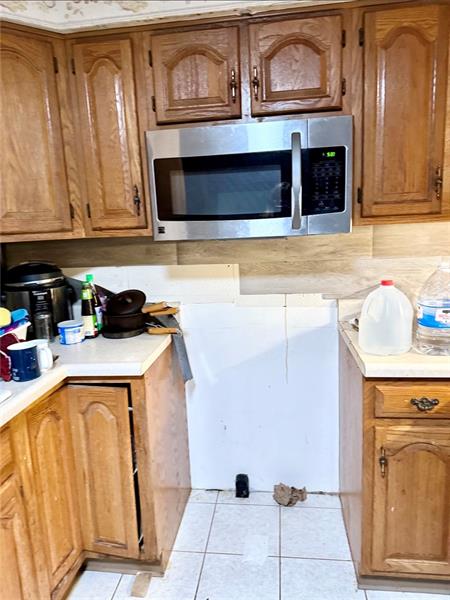 616 Sandy Hill Road Irwin, PA 15642 - Photo 11 of 38 a kitchen with granite countertop a stove top oven microwave and cabinets