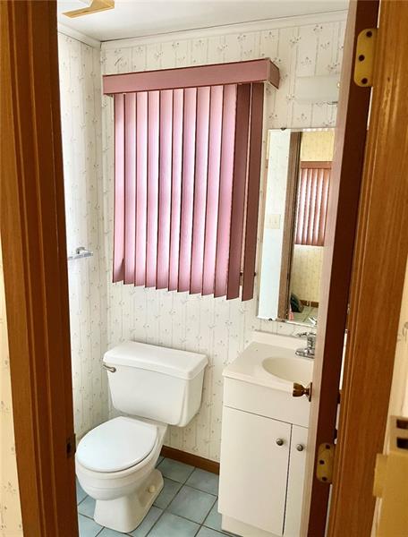 616 Sandy Hill Road Irwin, PA 15642 - Photo 17 of 38 a bathroom with a sink a toilet and a mirror