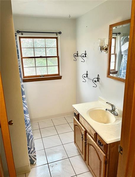 616 Sandy Hill Road Irwin, PA 15642 - Photo 20 of 38 a bathroom with a granite countertop sink a mirror and a bathtub