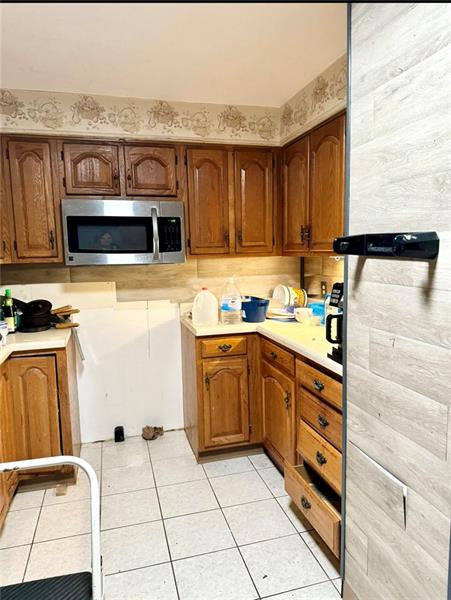 616 Sandy Hill Road Irwin, PA 15642 - Photo 9 of 38 a kitchen with stainless steel appliances kitchen island granite countertop a stove a sink and a microwave