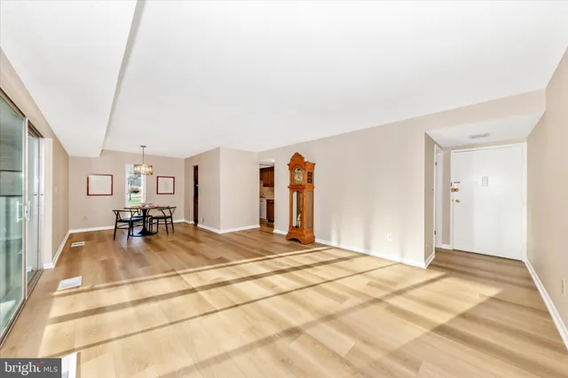 a view of a livingroom with wooden floor and a flat screen tv