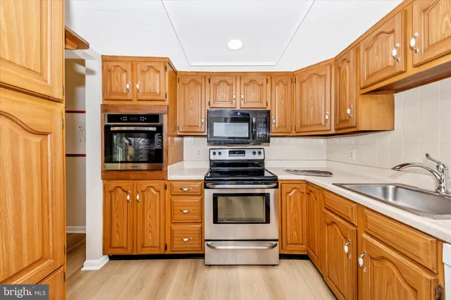 a kitchen with stainless steel appliances granite countertop a stove and a sink
