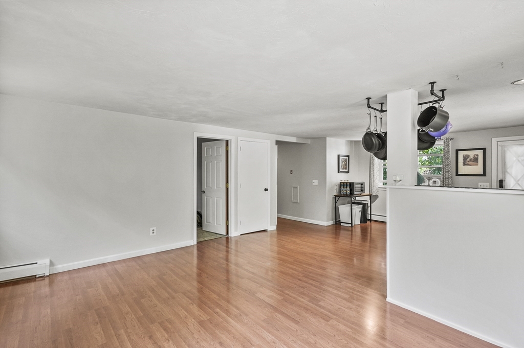 69 Appleton Road Auburn, MA 01501 - Photo 12 of 42 an empty room with wooden floor and windows