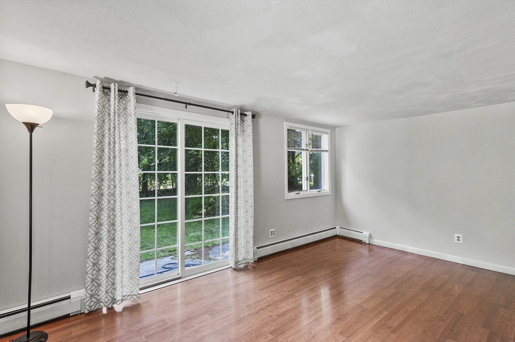 69 Appleton Road Auburn, MA 01501 - Photo 13 of 42 a view of an empty room with a window and wooden floor