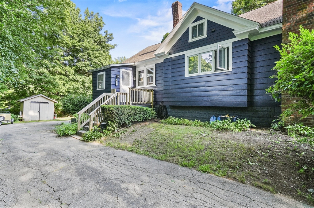 69 Appleton Road Auburn, MA 01501 - Photo 3 of 42 a front view of a house with a yard and garage