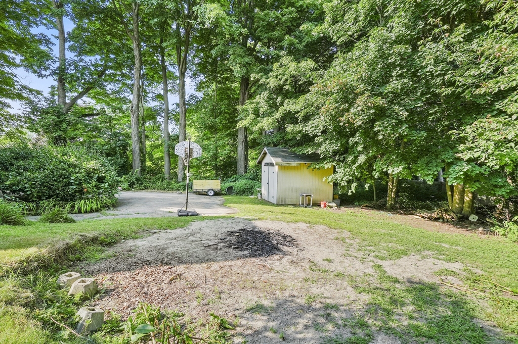 69 Appleton Road Auburn, MA 01501 - Photo 34 of 42 a big yard with flowing stream of water in middle