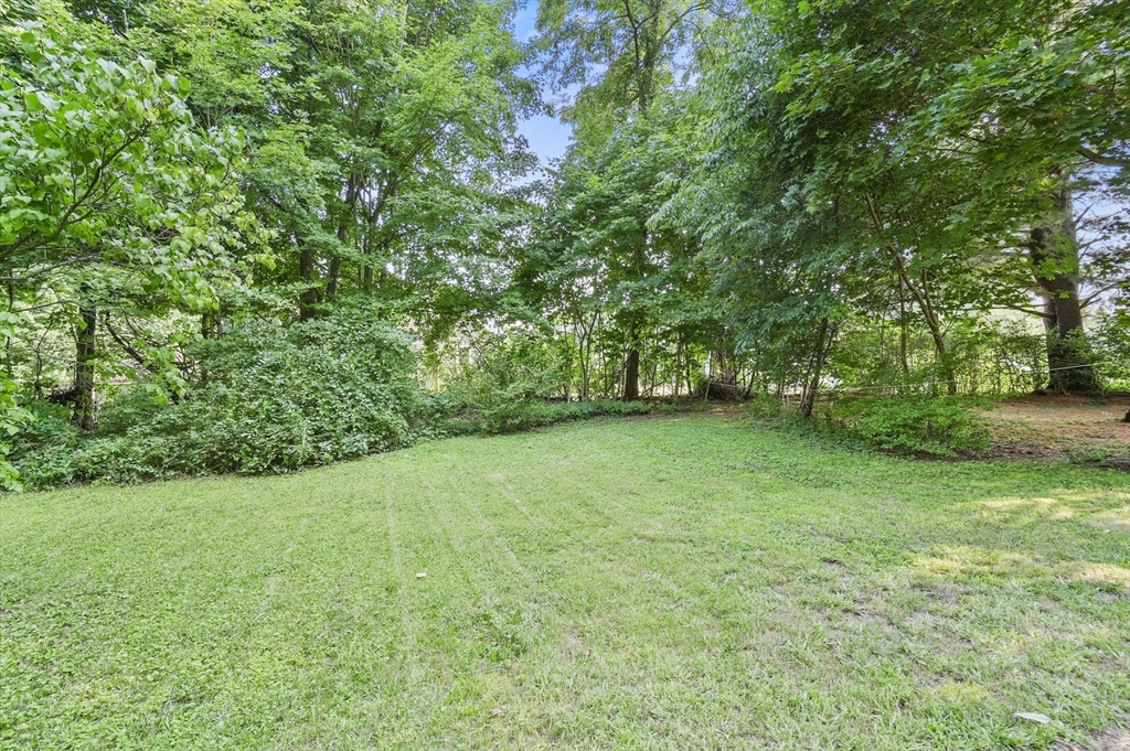 69 Appleton Road Auburn, MA 01501 - Photo 36 of 42 a view of a grassy field with trees