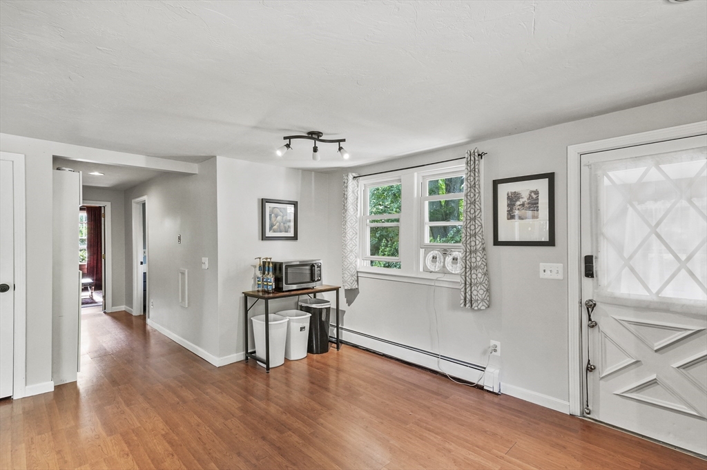 69 Appleton Road Auburn, MA 01501 - Photo 6 of 42 a view of a big room with wooden floor and windows
