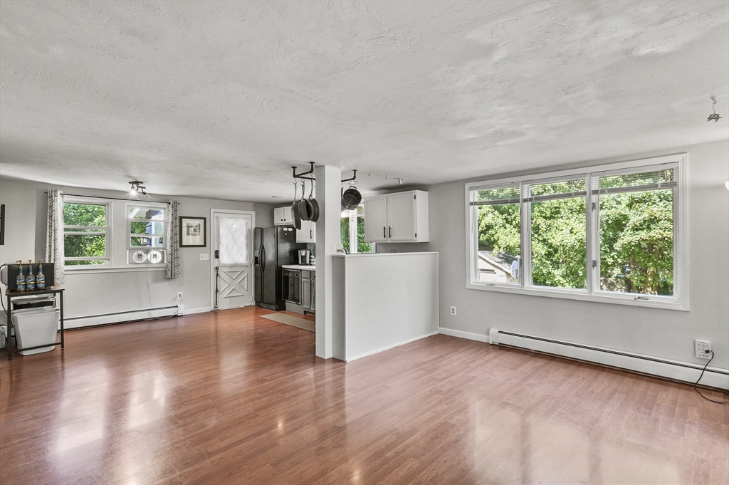 69 Appleton Road Auburn, MA 01501 - Photo 7 of 42 wooden floor in an empty room with a window and wooden floor