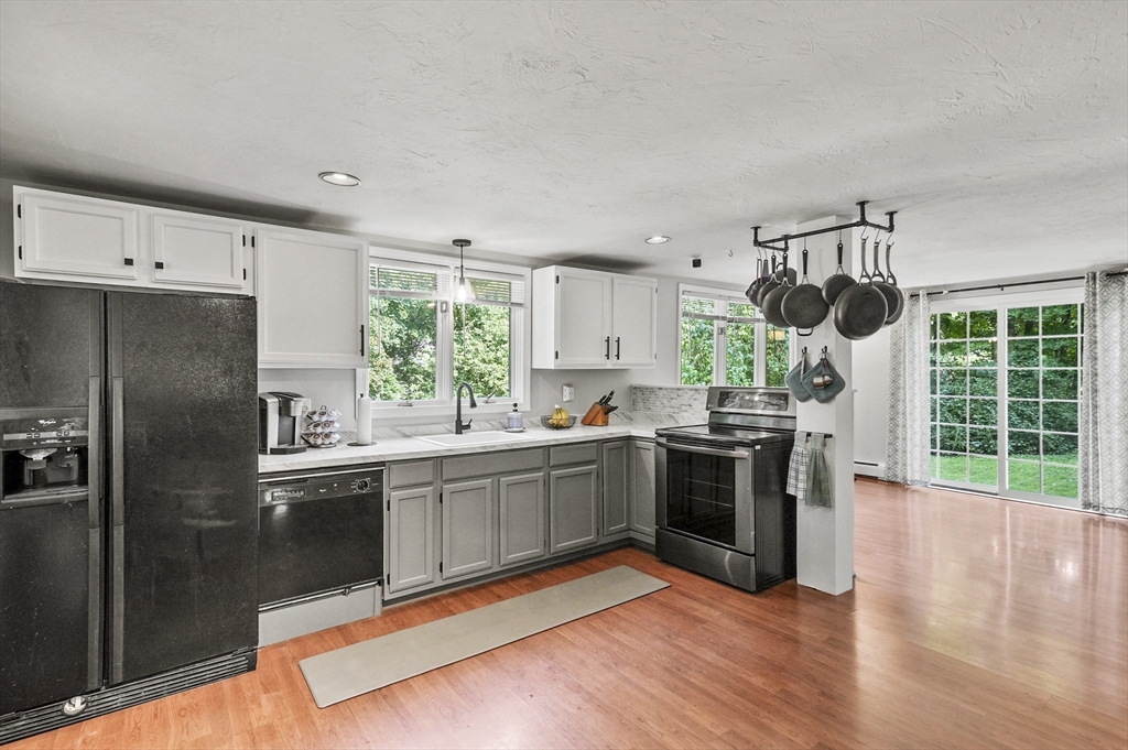 69 Appleton Road Auburn, MA 01501 - Photo 8 of 42 a kitchen with stainless steel appliances granite countertop a stove and a refrigerator