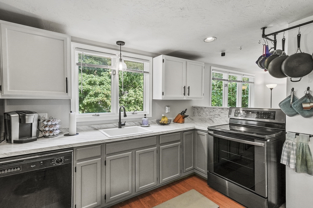 69 Appleton Road Auburn, MA 01501 - Photo 10 of 42 a kitchen with stainless steel appliances a stove sink and window
