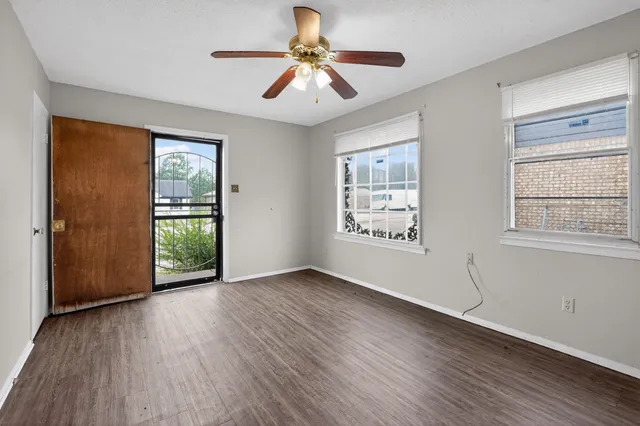 wooden floor in an empty room with a window