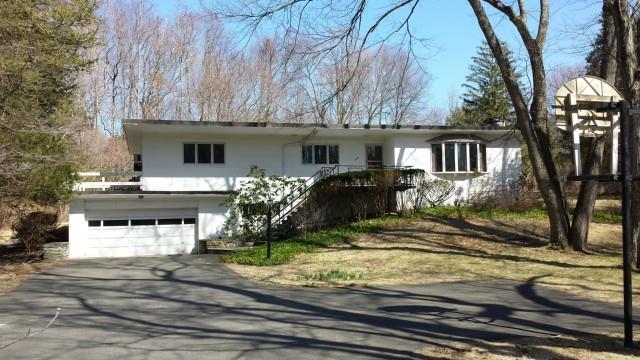 385 Den Road Stamford, CT 06903 - Photo 1 of 1 a view of a house with a yard