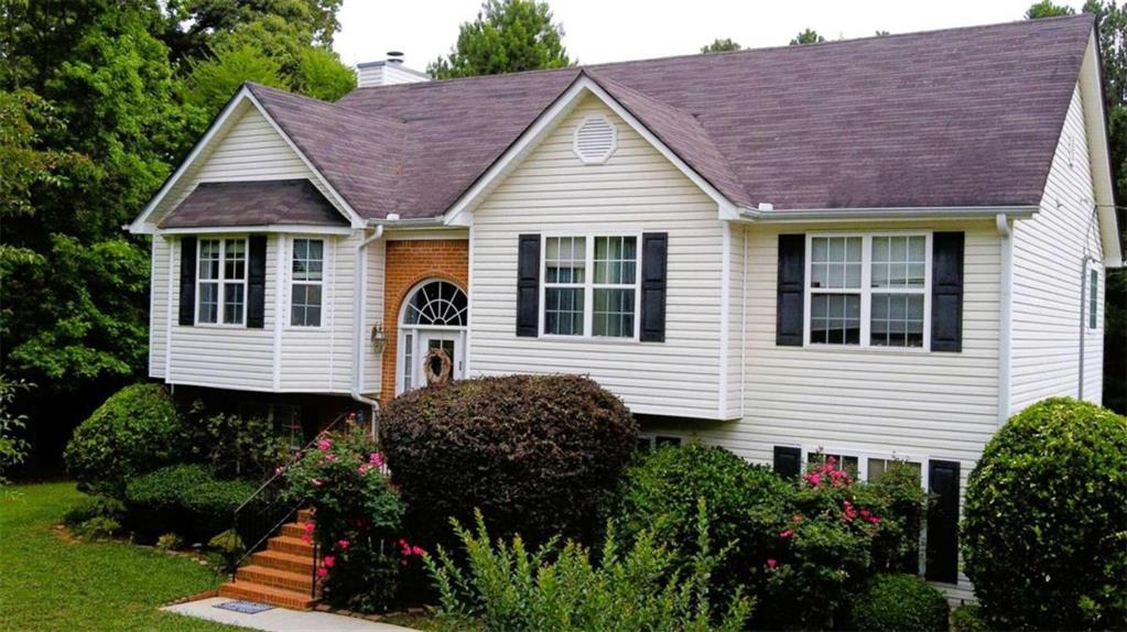 a front view of a house with garden