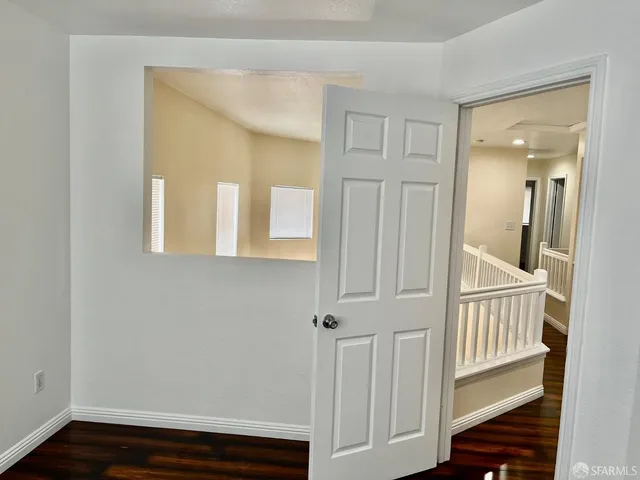 a view of an entryway with wooden floor