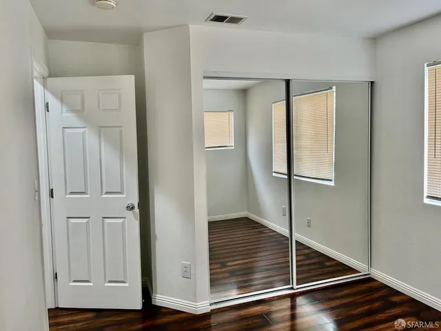 a view of a chandelier fan and wooden floor