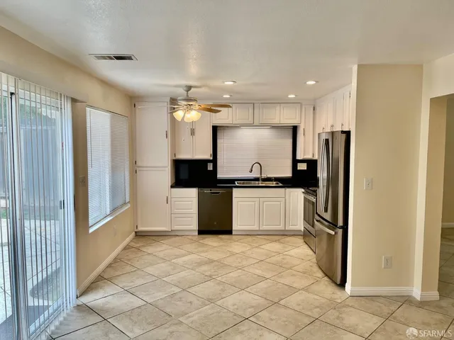 a kitchen with refrigerator a stove a microwave and cabinets