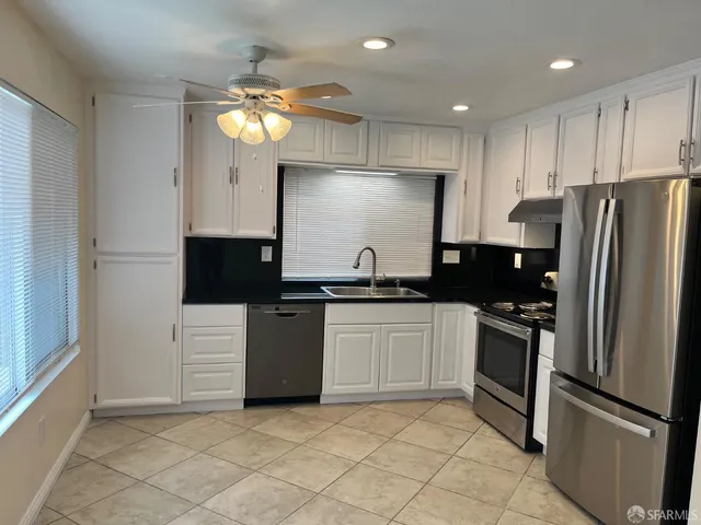a view of a porch with chairs and backyard