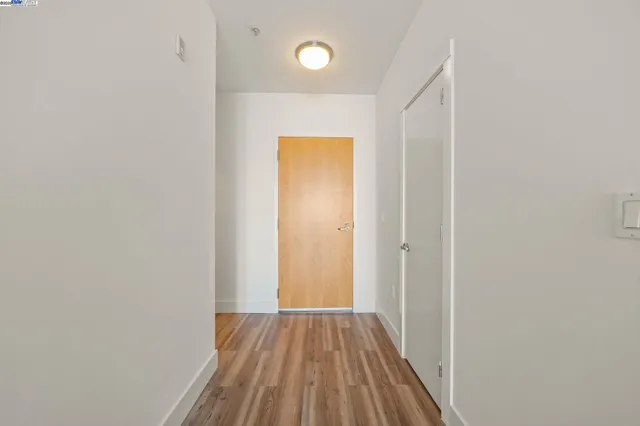 a view of a room with wooden floor
