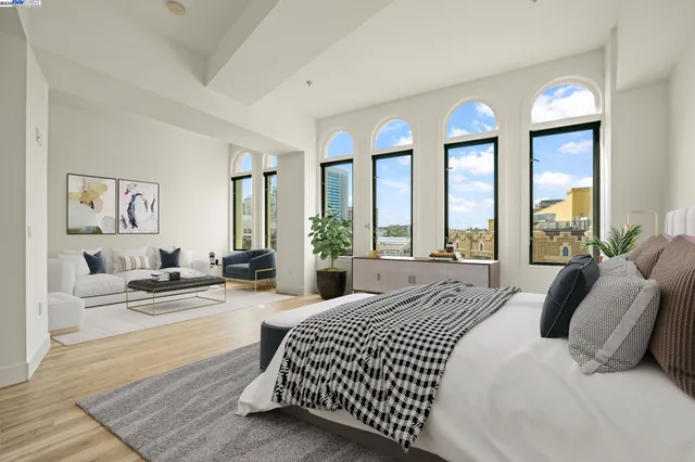 a spacious bedroom with a bed and glass windows