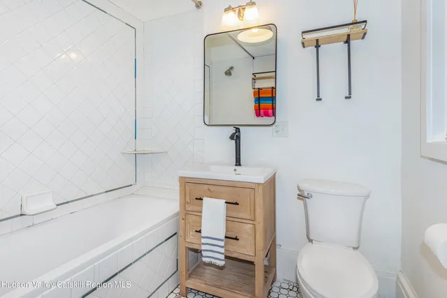 a bathroom with a sink and mirror