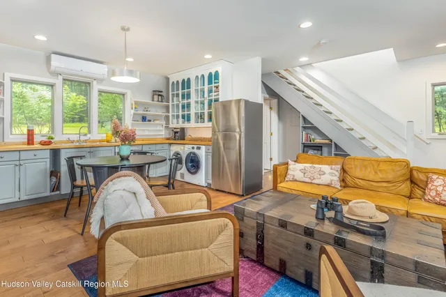 a spacious bedroom with a large bed and a large window