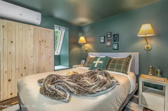 a picture of a room with a white wall and a painting