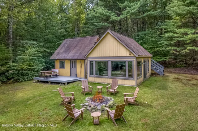 a view of a chairs and table in backyard of the house