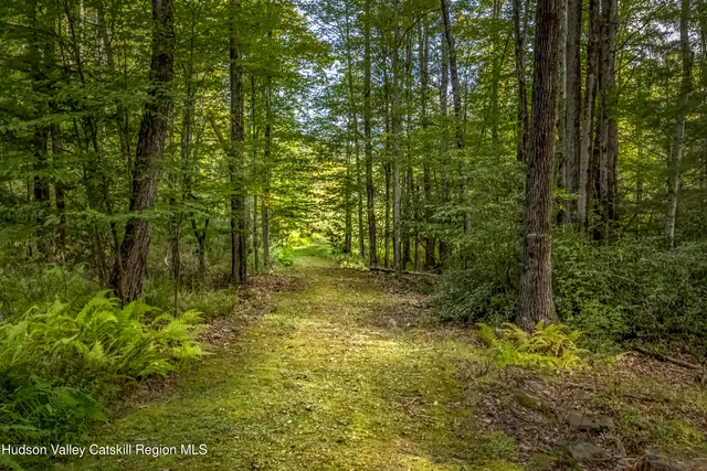 a wooden pier with boats in a lake