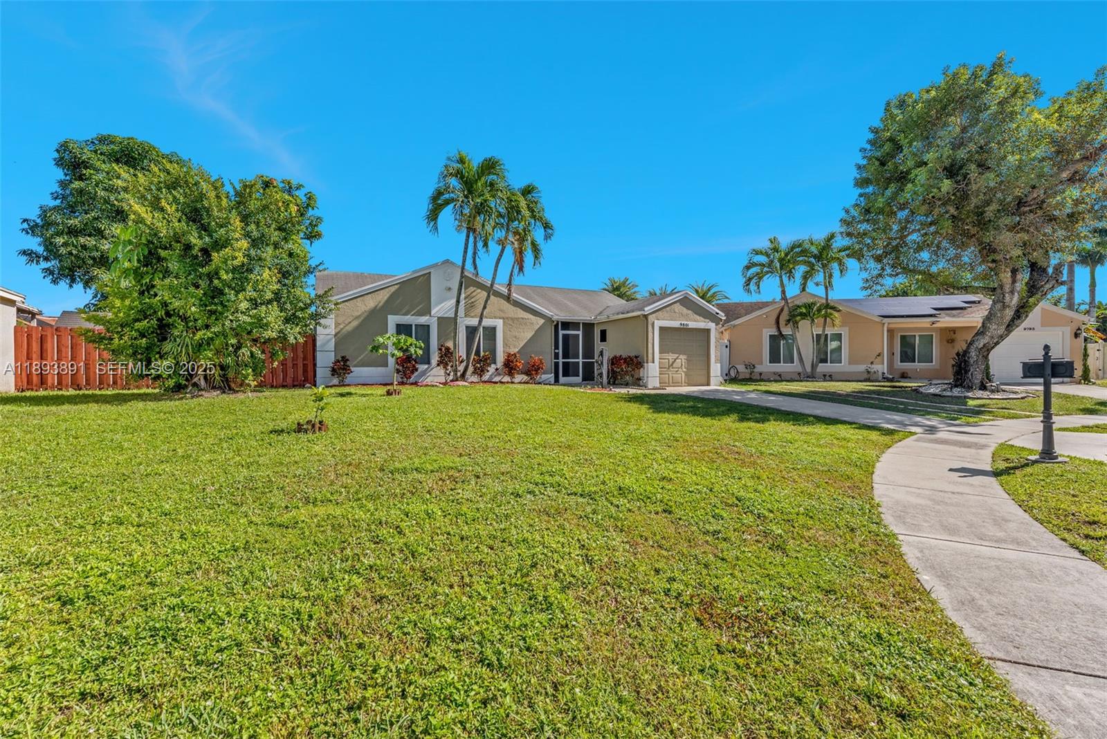 9801 Ridge Creek Road Boca Raton, FL 33496 - Photo 2 of 54 a house view with a garden space