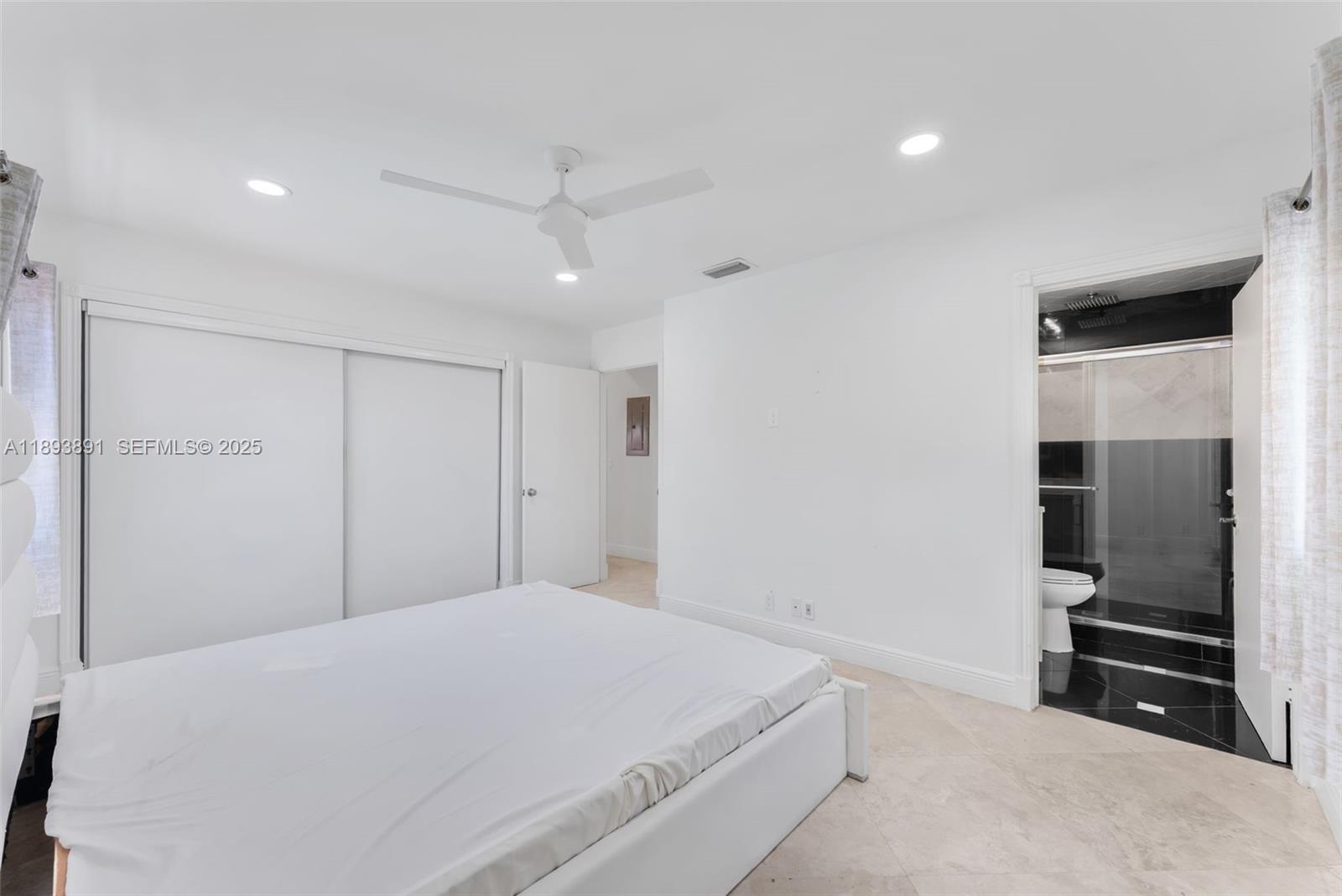 9801 Ridge Creek Road Boca Raton, FL 33496 - Photo 24 of 54 a bedroom with a bed and a walk in closet