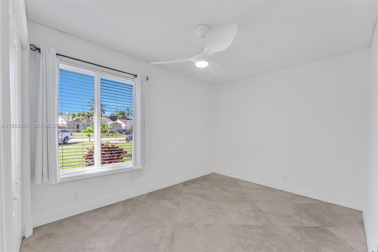 9801 Ridge Creek Road Boca Raton, FL 33496 - Photo 29 of 54 an empty room with a window