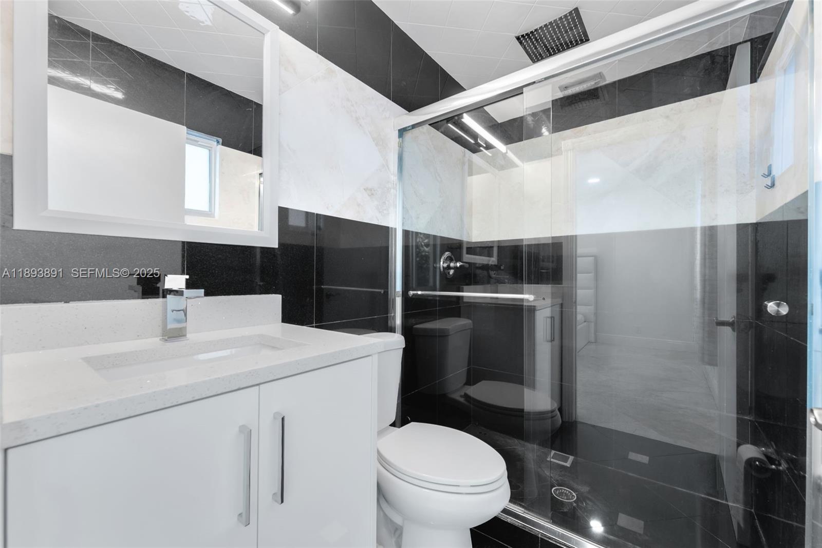 9801 Ridge Creek Road Boca Raton, FL 33496 - Photo 48 of 54 a bathroom with a sink toilet vanity and shower