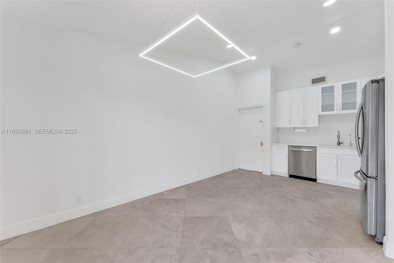 9801 Ridge Creek Road Boca Raton, FL 33496 - Photo 9 of 54 a view of a kitchen with a sink and a refrigerator