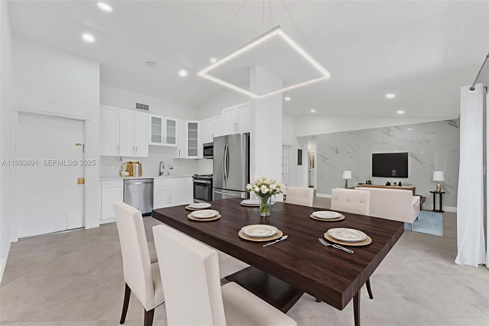 9801 Ridge Creek Road Boca Raton, FL 33496 - Photo 10 of 54 a kitchen with a dining table and chairs