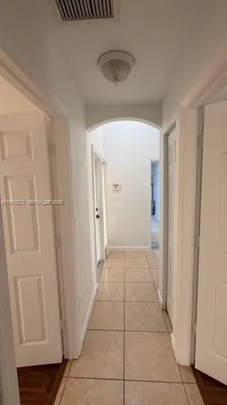 a view of a livingroom with an empty space and a window