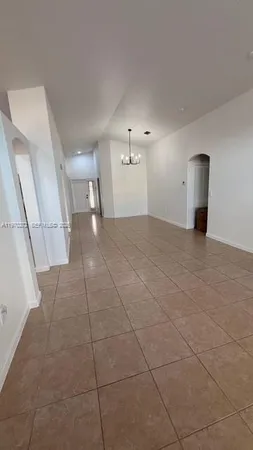 an empty room with an entrance and cabinet