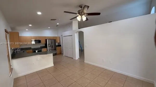 a kitchen with stainless steel appliances granite countertop a refrigerator and a stove top oven