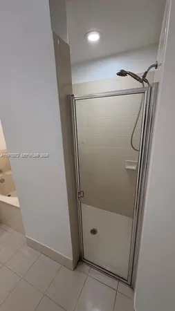 a bathroom with a bathtub sink and mirror