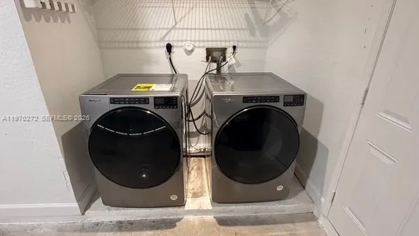 a hallway with a washer and dryer