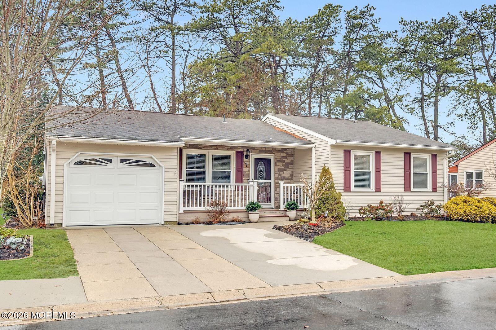 7 Eaton Lane, Unit 73 Whiting, NJ 08759 - Photo 1 of 37 a front view of a house with a yard and table and chairs
