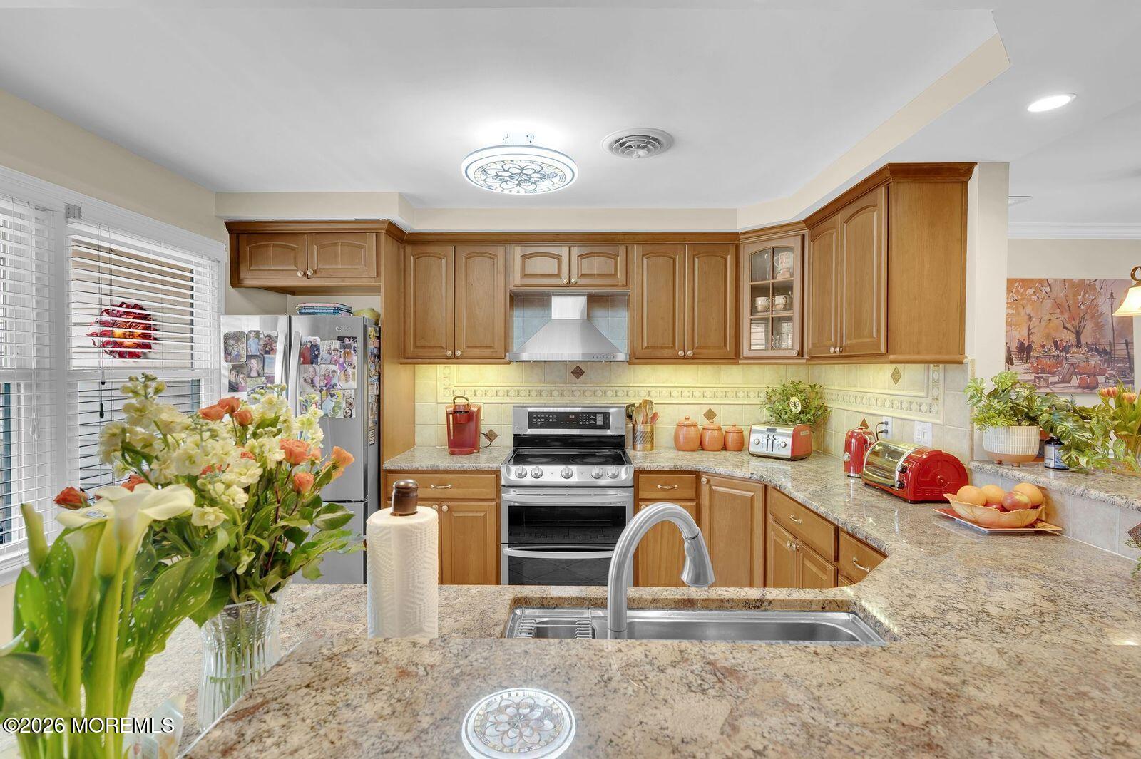 7 Eaton Lane, Unit 73 Whiting, NJ 08759 - Photo 14 of 37 a kitchen with stainless steel appliances granite countertop a stove a sink and a microwave